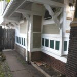 A charming home featuring a porch and a door, perfect for a warm welcome.