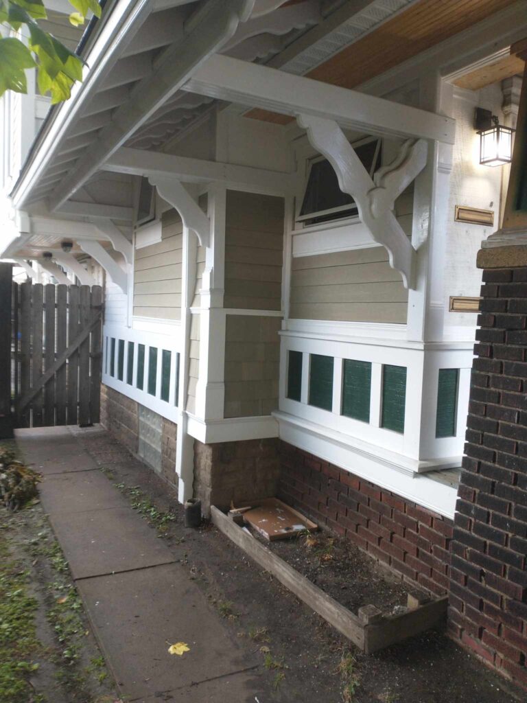 A charming home featuring a porch and a door, perfect for a warm welcome.