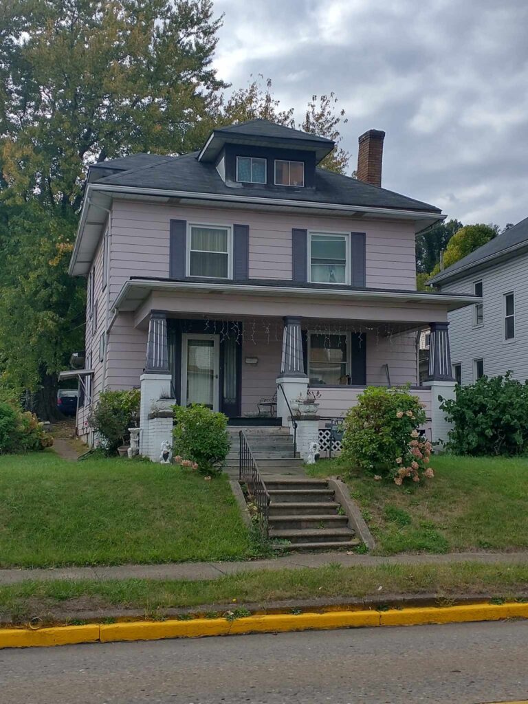 A residential house featuring a porch and a front porch, providing a welcoming entrance to the home.